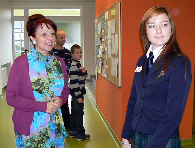 Hana Halfarová, the director of the Open Gate and University projects in The Kellner Family Foundation with a student of the Open Gate School in a festive uniform